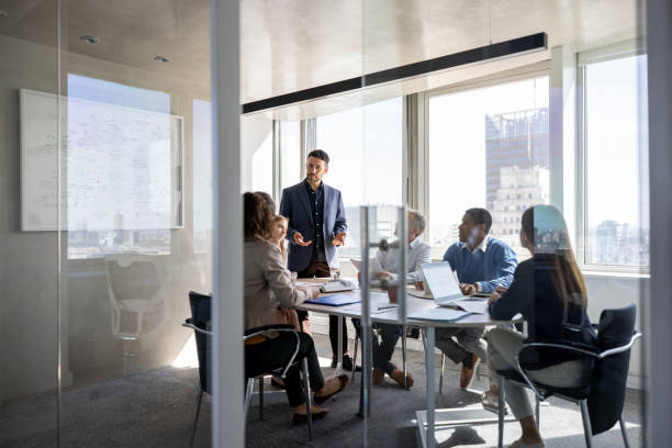 successful-business-man-talking-to-a-group-of-people-in-a-meeting-a-the-office